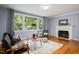 Cozy living room with hardwood floors, fireplace, and large windows for ample natural light at 418 Ridgefield Rd, Chapel Hill, NC 27517