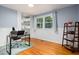Bright office featuring built-in shelves, natural light, and hardwood flooring at 418 Ridgefield Rd, Chapel Hill, NC 27517