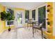 Bright sun room with large windows, tile floor and seating area, perfect for relaxation at 418 Ridgefield Rd, Chapel Hill, NC 27517