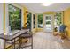 Sun-drenched sun room with tile floors, multiple windows offering serene views, and a cozy seating arrangement at 418 Ridgefield Rd, Chapel Hill, NC 27517