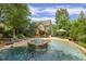 A private backyard oasis with a pool, hot tub, and patio perfect for relaxation and entertaining at 4221 Bibleway Ct, Holly Springs, NC 27540