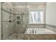 Elegant bathroom featuring a soaking tub, large shower, and decorative mosaic tile accents at 4221 Bibleway Ct, Holly Springs, NC 27540