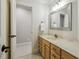 Bathroom with a single sink, a light wood cabinet, and an adjoining room at 4221 Bibleway Ct, Holly Springs, NC 27540