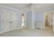 Bedroom featuring neutral colored walls, white doors, white trim, and a glimpse into the bathroom at 4221 Bibleway Ct, Holly Springs, NC 27540