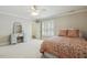 Bedroom with a large bed, white shutters, and a vanity with a mirror at 4221 Bibleway Ct, Holly Springs, NC 27540