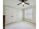 Bedroom with white carpet, large double-door closet, and a window with white shutters at 4221 Bibleway Ct, Holly Springs, NC 27540
