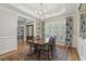 Elegant dining room with large windows, a chandelier, and patterned curtains at 4221 Bibleway Ct, Holly Springs, NC 27540