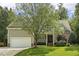 Charming home featuring a beautiful lawn and a two-car garage, providing ample space for parking at 4221 Bibleway Ct, Holly Springs, NC 27540