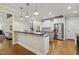 Well-equipped kitchen with stainless steel appliances, granite countertops, and an open design at 4221 Bibleway Ct, Holly Springs, NC 27540