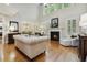 Bright and airy living room featuring a fireplace, hardwood floors, and large windows for natural light at 4221 Bibleway Ct, Holly Springs, NC 27540