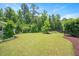 Lush backyard featuring a well-manicured lawn and privacy fencing at 425 Cottonseed Way, Durham, NC 27703