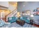 Spacious living room with soaring ceilings, comfortable seating, and a staircase at 425 Cottonseed Way, Durham, NC 27703