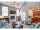 Inviting living room with a fireplace, high ceilings, and seamless access to the kitchen at 425 Cottonseed Way, Durham, NC 27703