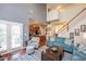 Bright living room showcasing natural light and open floor plan to the kitchen at 425 Cottonseed Way, Durham, NC 27703
