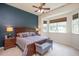 A spacious bedroom featuring a large window, a ceiling fan, and neutral decor at 425 Cottonseed Way, Durham, NC 27703