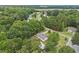 This aerial view showcases a home nestled among lush greenery in a peaceful neighborhood at 436 Madison Ave, Princeton, NC 27569