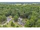 This house has a spacious backyard with deck, outbuildings, and mature trees, all in a serene wooded setting at 436 Madison Ave, Princeton, NC 27569
