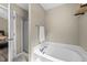 Bright bathroom featuring a bathtub, a walk-in shower, and neutral-toned walls at 436 Madison Ave, Princeton, NC 27569