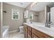 Bright bathroom featuring a double sink vanity, natural light, and neutral-toned walls at 436 Madison Ave, Princeton, NC 27569