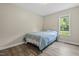 Comfortable bedroom with wood-look flooring, a window, and a queen-sized bed at 436 Madison Ave, Princeton, NC 27569