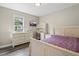 Well-lit bedroom with wood-look flooring, a bed, a desk, and a dresser at 436 Madison Ave, Princeton, NC 27569