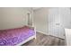 Bedroom with wood-look flooring, a bed, a closet, and painted walls at 436 Madison Ave, Princeton, NC 27569