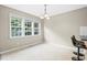 Bright dining area with large windows and modern lighting fixture, adjacent to kitchen at 436 Madison Ave, Princeton, NC 27569