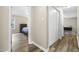 Hallway with hardwood floors leads to the bedroom featuring a ceiling fan at 436 Madison Ave, Princeton, NC 27569