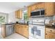 Kitchen with stainless steel dishwasher, range and microwave, and light wood cabinetry at 436 Madison Ave, Princeton, NC 27569