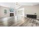 Bright living room with fireplace, vaulted ceiling, and sleek modern floors at 436 Madison Ave, Princeton, NC 27569
