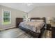Spacious main bedroom with vaulted ceiling, windows offering outside views, and hardwood floors at 436 Madison Ave, Princeton, NC 27569