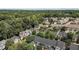 Expansive aerial view of a neighborhood surrounded by lush trees and greenery, offering a serene living environment at 440 Heritage Village Ln, Apex, NC 27502