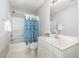 Bathroom with a shower and tub combination and a blue and white patterned shower curtain at 440 Heritage Village Ln, Apex, NC 27502
