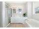 Bright bathroom featuring double sinks, white cabinetry, and a walk in shower at 440 Heritage Village Ln, Apex, NC 27502