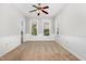 This bedroom features neutral carpet, two windows, and a ceiling fan at 440 Heritage Village Ln, Apex, NC 27502