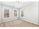 This carpeted bedroom has two windows with blinds and neutral walls at 440 Heritage Village Ln, Apex, NC 27502
