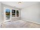 Carpeted bedroom with a window, door to balcony, and neutral walls at 440 Heritage Village Ln, Apex, NC 27502