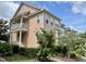Charming two-story condo with a welcoming porch and well-maintained landscaping under a bright, cloudy sky at 440 Heritage Village Ln, Apex, NC 27502