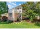 Exterior shot of a home with a balcony and patio and a manicured lawn at 440 Heritage Village Ln, Apex, NC 27502