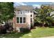Rear exterior of a home with a balcony, patio, and landscaped backyard at 440 Heritage Village Ln, Apex, NC 27502