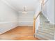 Light-filled living room with hardwood floors, crown molding, neutral walls, a staircase, and a chandelier at 440 Heritage Village Ln, Apex, NC 27502