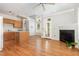 Inviting living space with hardwood floors, fireplace, and an open floor plan connecting to the kitchen, creating a seamless flow at 440 Heritage Village Ln, Apex, NC 27502