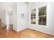 Bright living area with hardwood floors, staircase, and large windows allowing ample natural light, creating a warm atmosphere at 440 Heritage Village Ln, Apex, NC 27502