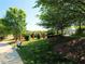 Scenic park view with a bench, walking path, and well-maintained landscaping, creating a peaceful retreat at 440 Heritage Village Ln, Apex, NC 27502