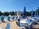 Inviting community pool area with chairs, umbrellas, and a clubhouse, creating a relaxing environment at 440 Heritage Village Ln, Apex, NC 27502
