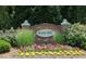 Attractive entrance sign for Scotts Mill, surrounded by lush landscaping and colorful flowers, creating curb appeal at 440 Heritage Village Ln, Apex, NC 27502