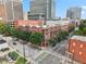 Aerial view of the community showcasing the brick buildings and surrounding greenery at 444 S Blount St # 209, Raleigh, NC 27601