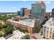 Aerial view of the community buildings surrounded by lush trees and green space at 444 S Blount St # 209, Raleigh, NC 27601