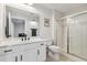 Bright bathroom with modern fixtures, white cabinets, shower and sleek glass door at 444 S Blount St # 209, Raleigh, NC 27601