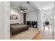 Spacious bedroom with soft carpet, fan, and art accent at 444 S Blount St # 209, Raleigh, NC 27601